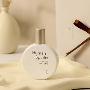 Human Sparks Eau de Parfum bottle displayed for long-lasting fragrance in elegant setting.